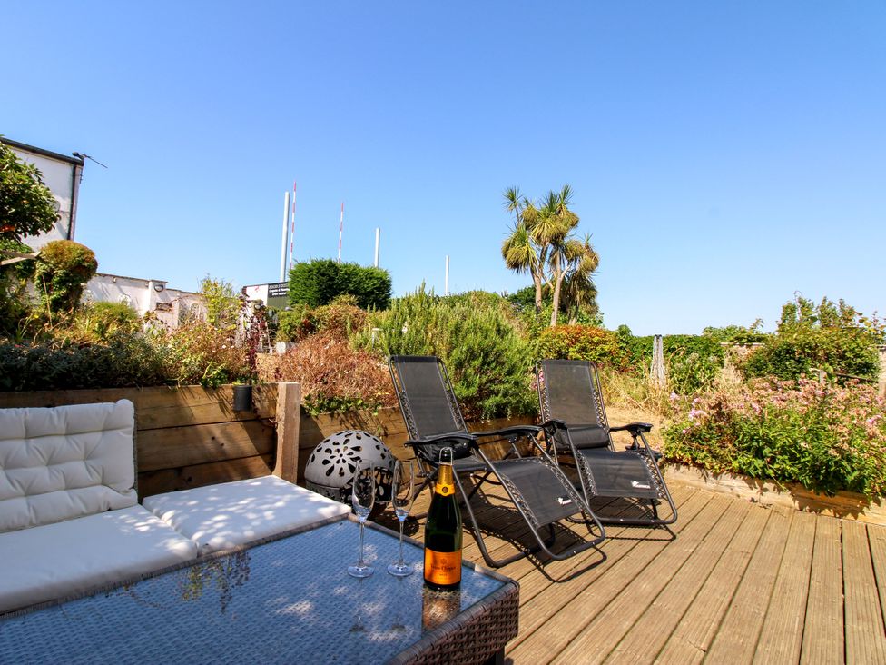 An outdoor space with a couch and table at Lorrell in Salcombe