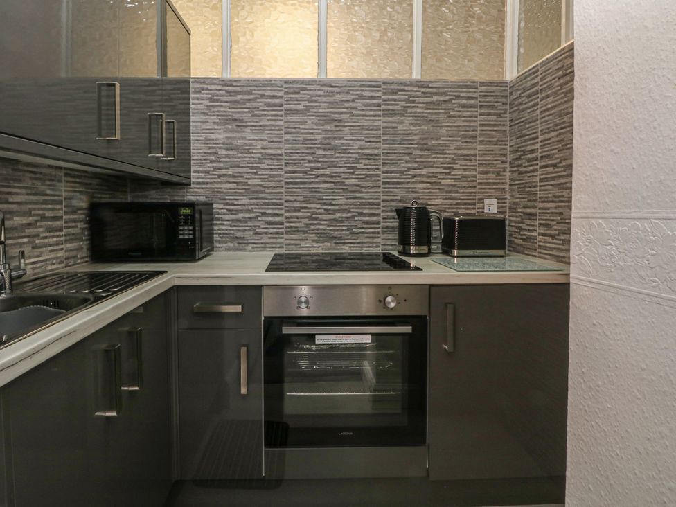 A kitchen with a sink and appliances at Apartment 2 in Lytham St. Annes