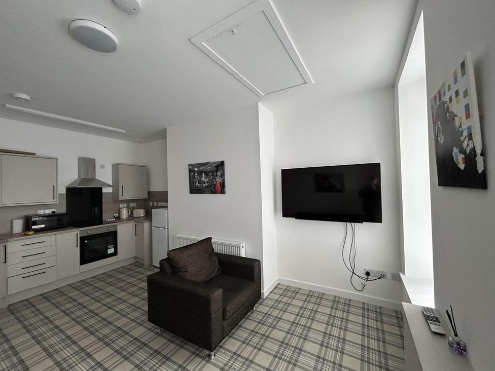 A living room with a sofa and television at Buckie Haven 3 Bed Contractors Business Travellers in Buckie