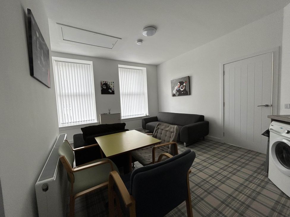 A living room with a sofa, armchairs, and a coffee table at Buckie Haven 3 Bed Contractors Business Travellers in Buckie