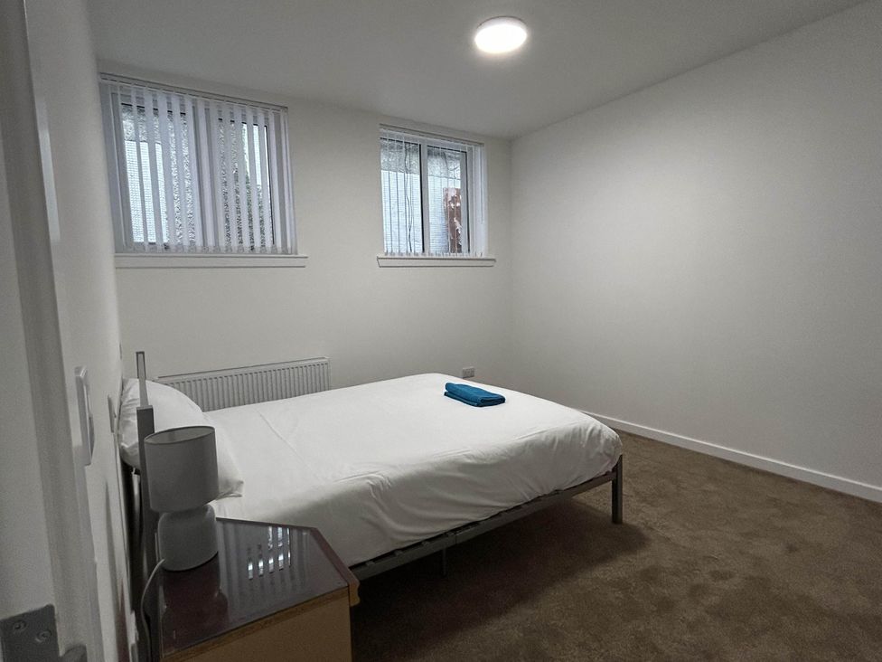 A bedroom with a bed and a towel on it at Buckie Haven 3 Bed Contractors Business Travellers in Buckie