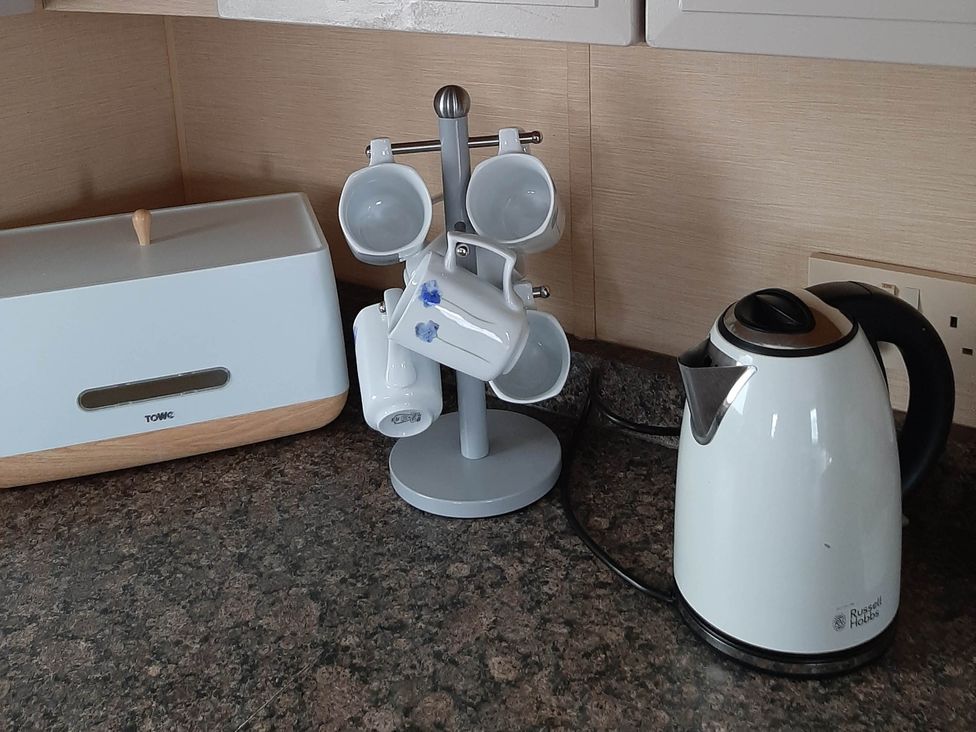A kitchen with a kettle and cup holder at Taid's Retreat Silversands Cove beach lossiemouth