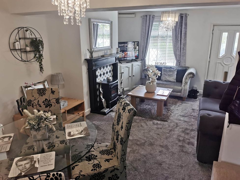 A living room with a sofa and television at Stunning 2-Bed House in Macclesfield Cheshire