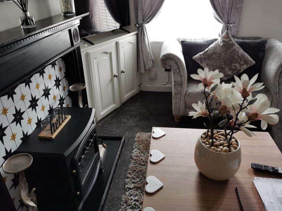 A living room with a sofa and coffee table at Stunning 2-Bed House in Macclesfield Cheshire