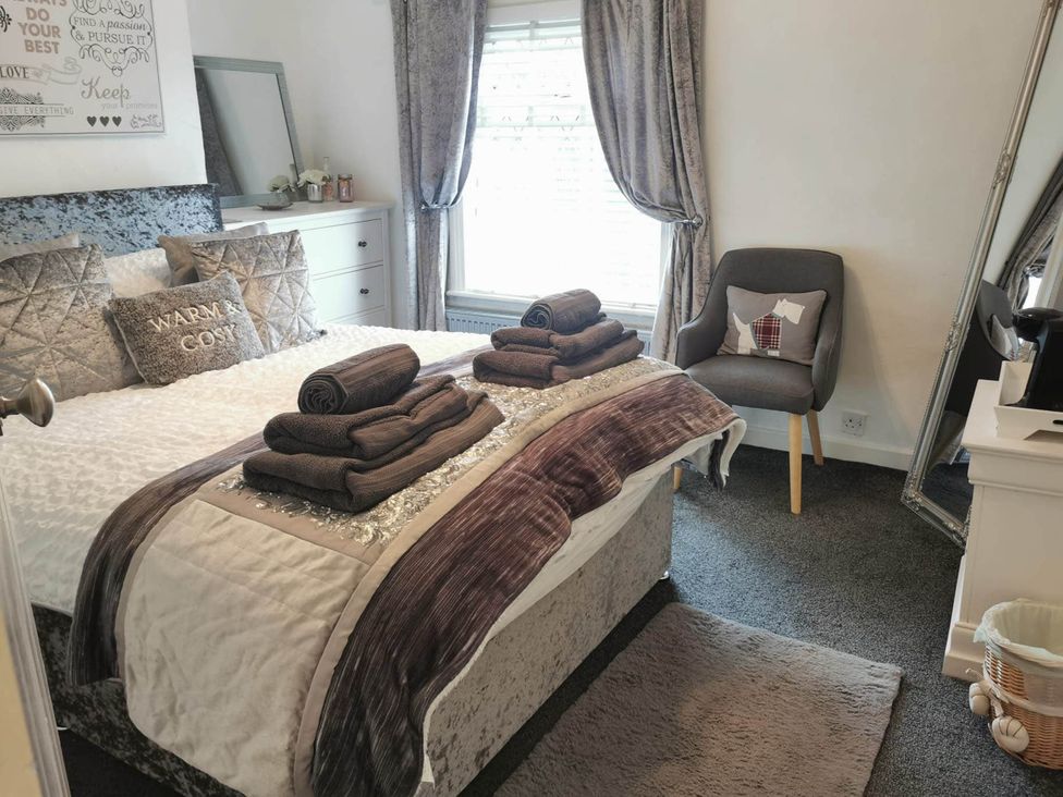 A bedroom with a bed and towels arranged neatly at Stunning 2-Bed House in Macclesfield Cheshire