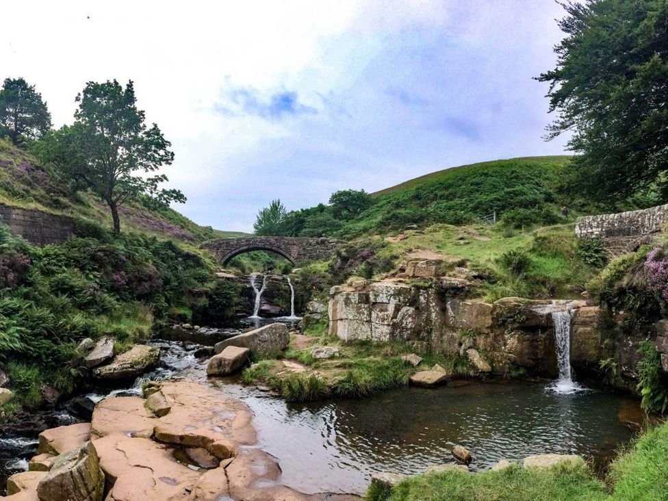 A natural landscape with a stone bridge and waterfall at Stunning 2-Bed House in Macclesfield Cheshire
