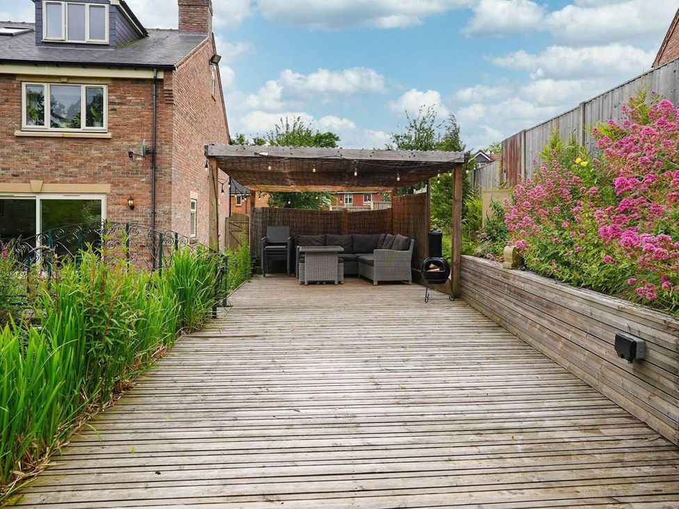 An outdoor seating area under a pergola at Rent My Spa Home with Pool table, Hottub and Sauna Chesterfield