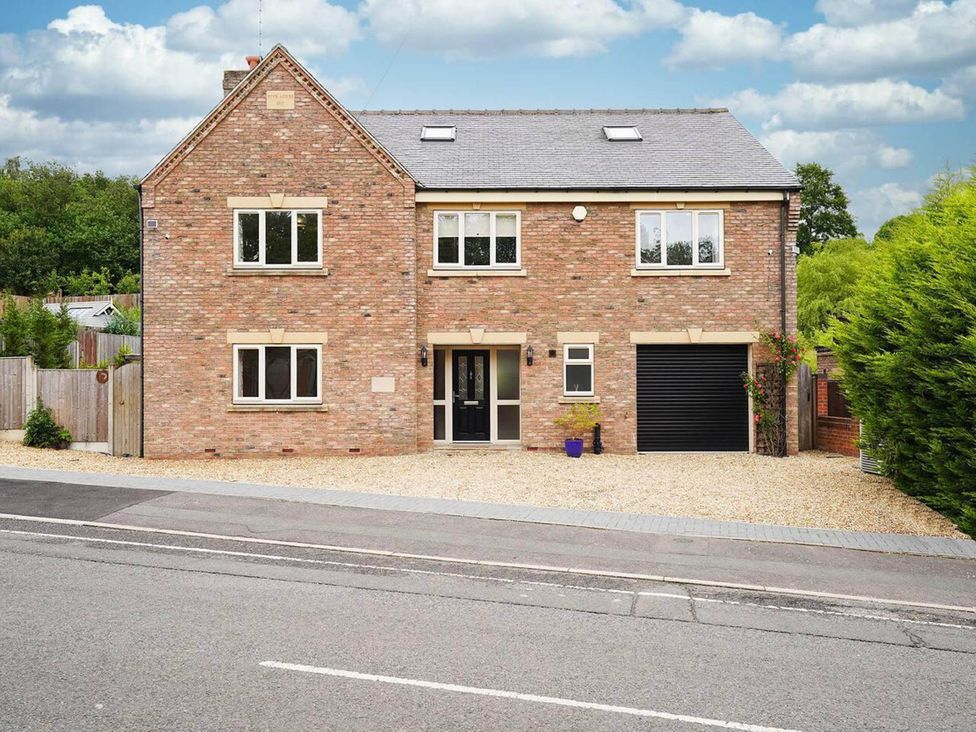A house with a garage and front door at Rent My Spa Home with Pool table, Hottub and Sauna Chesterfield