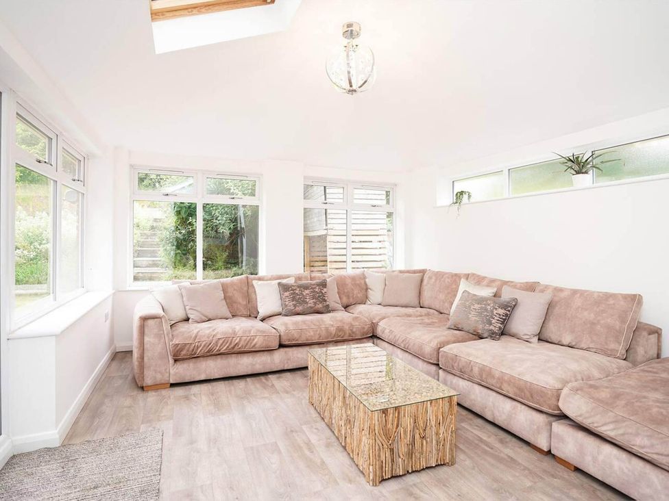 A snug area with a sofa and a coffee table at Rent My Spa Home with Pool table, Hottub and Sauna Chesterfield
