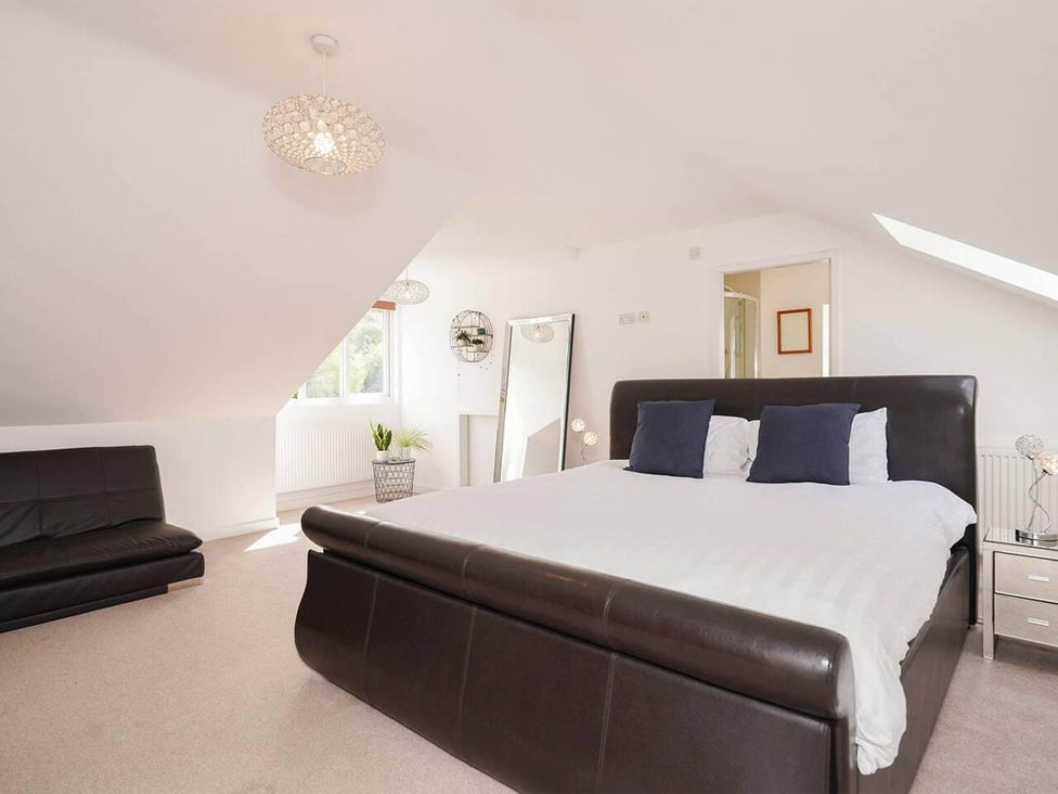 A bedroom with a bed and sofa at Rent My Spa Home with Pool table, Hottub and Sauna Chesterfield