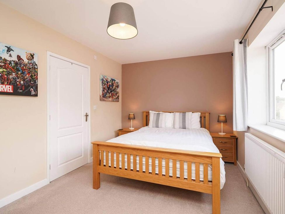 A bedroom with a double bed and bedside table at Rent My Spa Home with Pool table, Hottub and Sauna Chesterfield