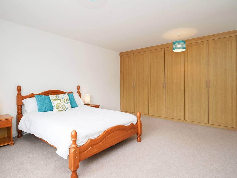 A bedroom with a bed and wardrobe at Rent My Spa Home with Pool table, Hottub and Sauna Chesterfield