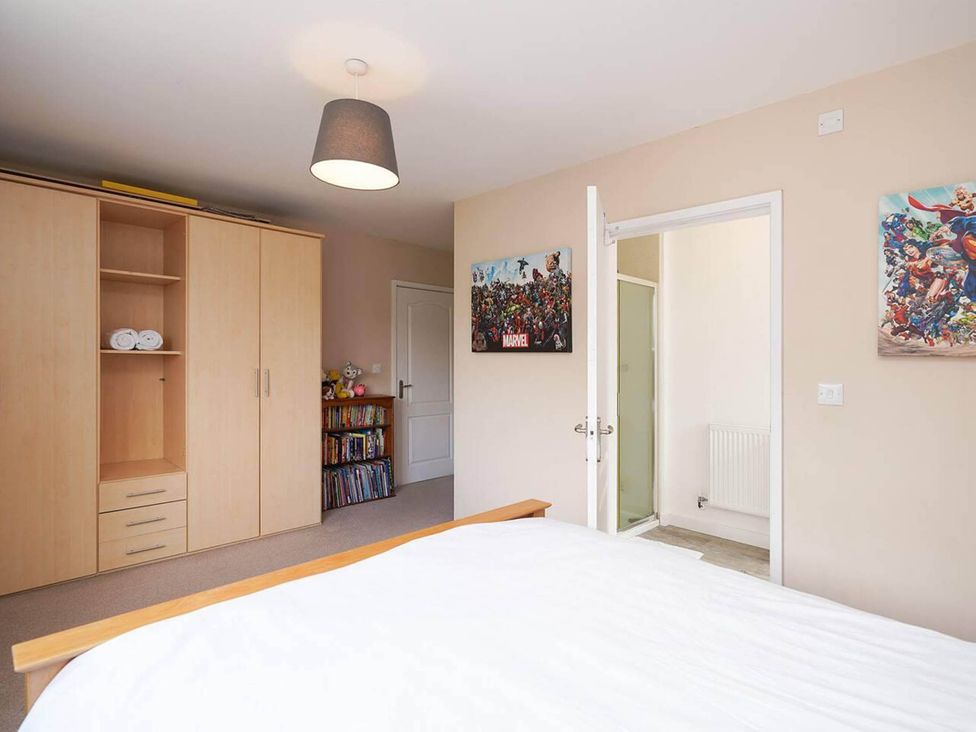 A bedroom with a bed, wardrobe, and bookshelf at Rent My Spa Home with Pool table, Hottub and Sauna in Chesterfield