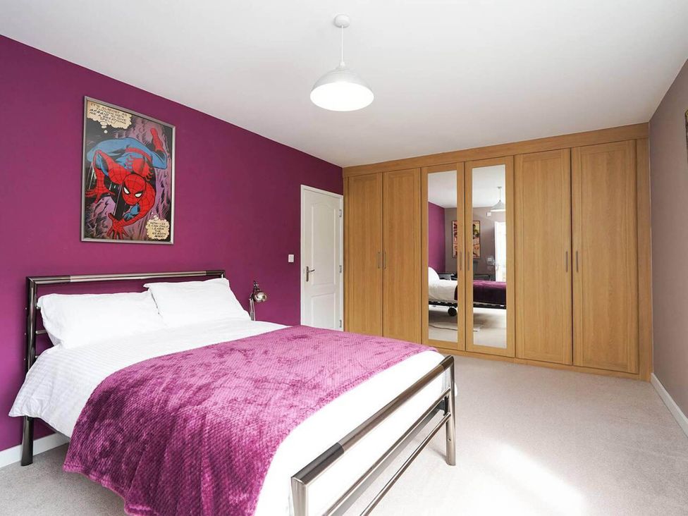 A bedroom with a bed and wardrobe at Rent My Spa Home with Pool table, Hottub and Sauna in Chesterfield