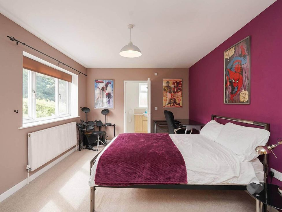 A bedroom with a bed and desk at Rent My Spa Home with Pool table, Hottub and Sauna Chesterfield