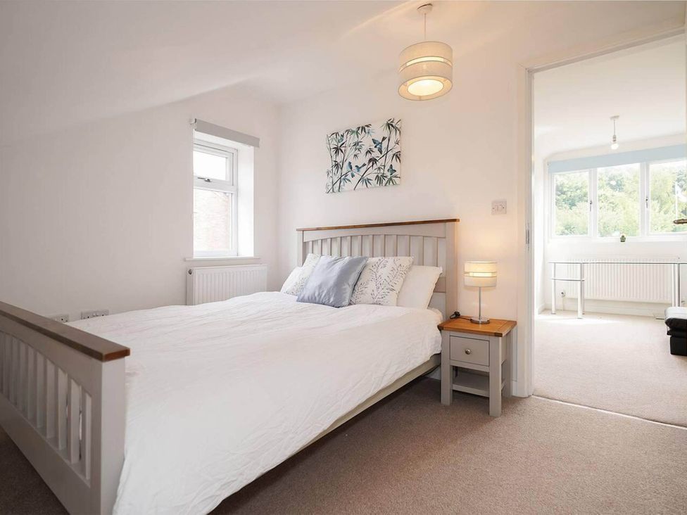 A bedroom with a bed and a bedside table at Rent My Spa Home with Pool table, Hottub and Sauna Chesterfield
