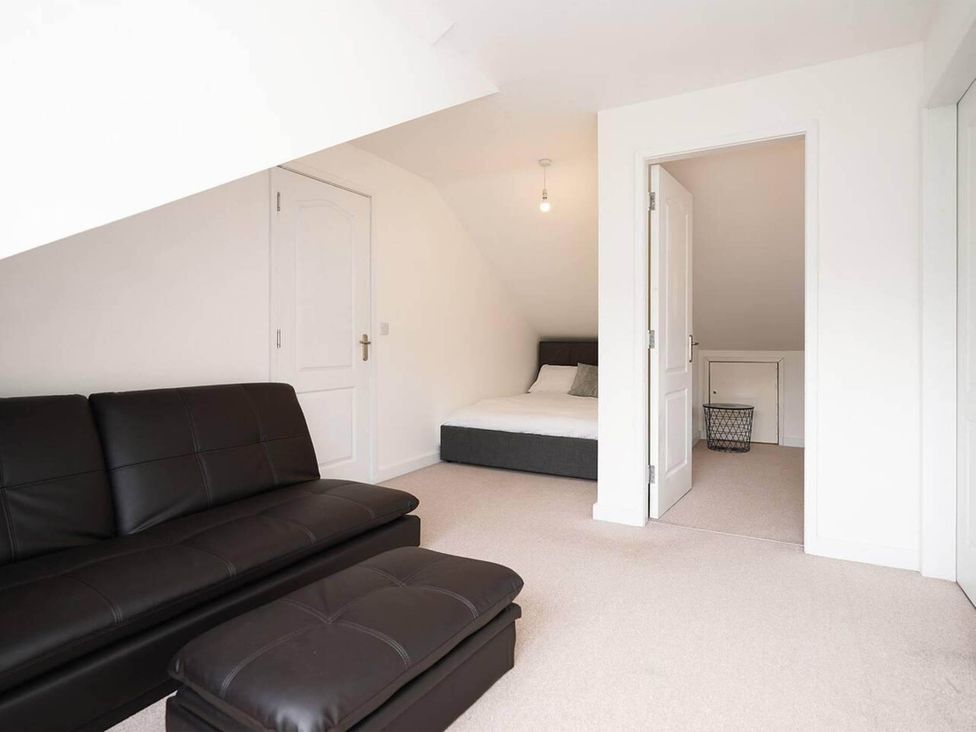 A bedroom with a sofa and bed at Rent My Spa Home with Pool table, Hottub and Sauna in Chesterfield