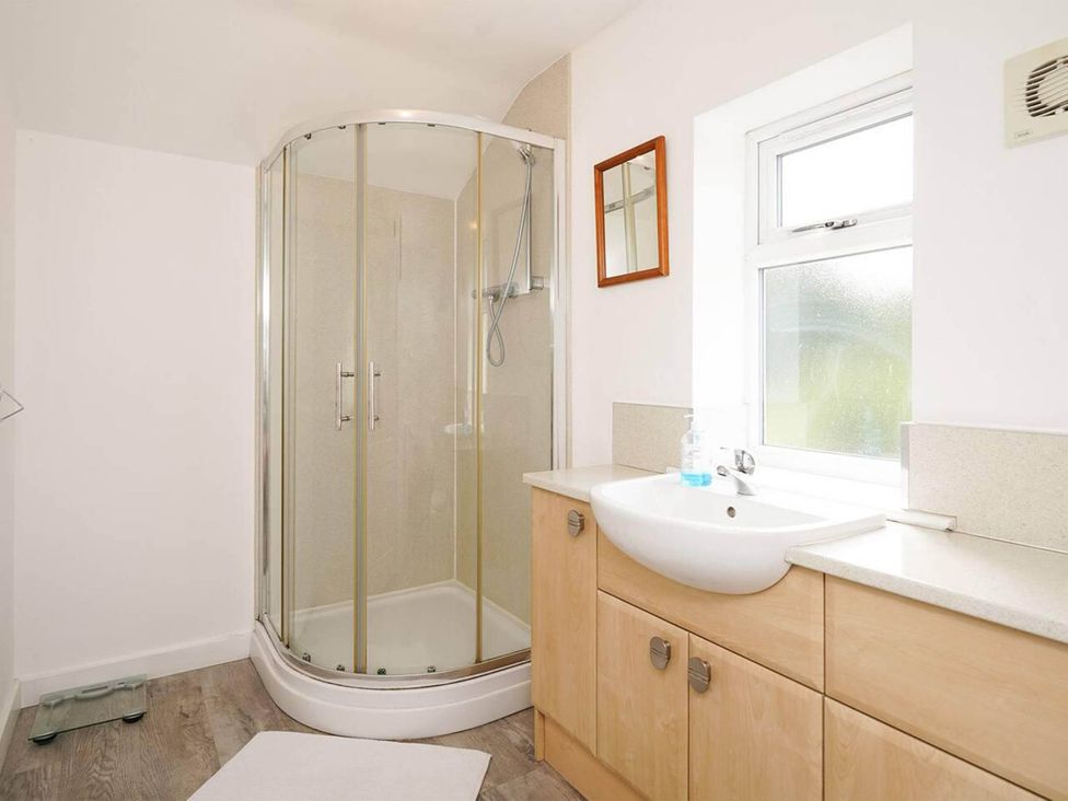 A bathroom with a shower, sink, and cabinet at Rent My Spa Home with Pool table, Hottub and Sauna, Chesterfield