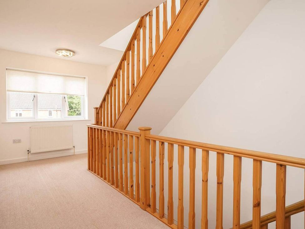 A landing with a staircase and window at Rent My Spa Home with Pool table, Hottub and Sauna in Chesterfield