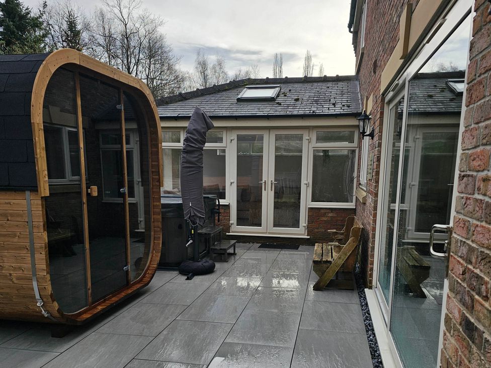 An outdoor area with a wooden spa structure and hot tub at Rent My Spa Home with Pool table, Hottub and Sauna Chesterfield