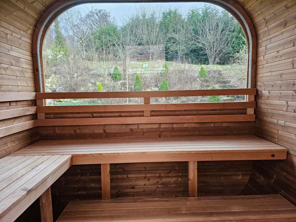 A sauna with wooden benches and a window at Rent My Spa Home with Pool table, Hottub and Sauna in Chesterfield