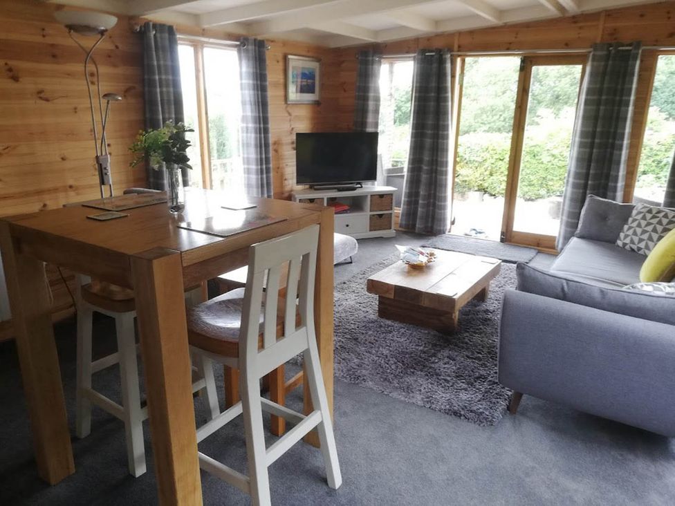 A living room with a table and stools at Peaceful Cabin in Skegby -Sleeps2- Fire Pit Stanton Hill