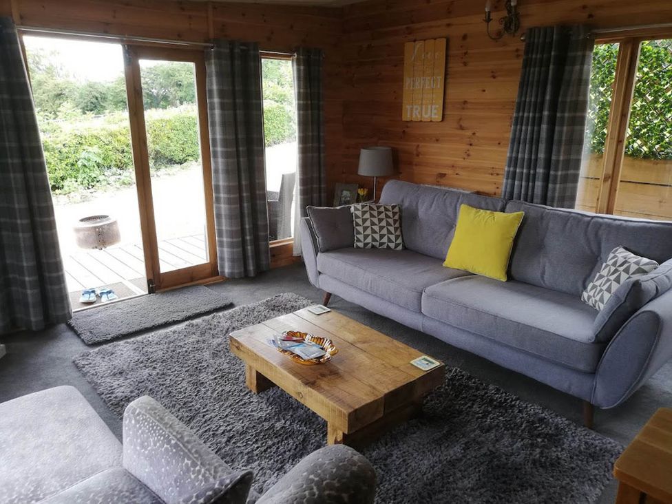 A living room with a sofa and coffee table at Peaceful Cabin in Skegby -Sleeps2- Fire Pit Stanton Hill