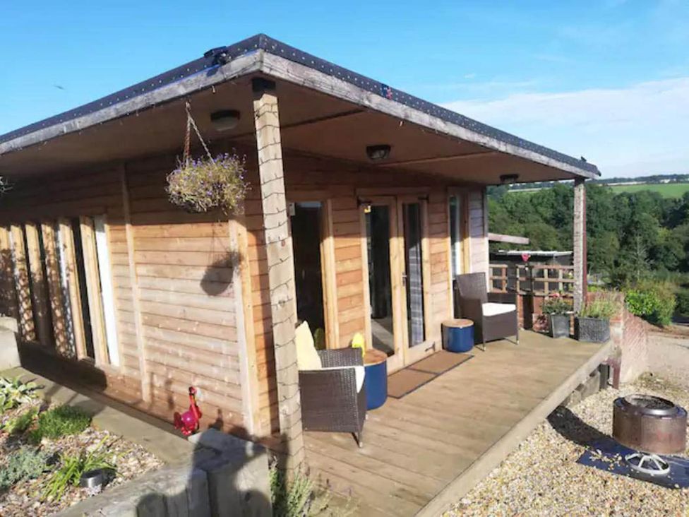 An outdoor area with a cabin and seating at Peaceful Cabin in Skegby -Sleeps2- Fire Pit Stanton Hill