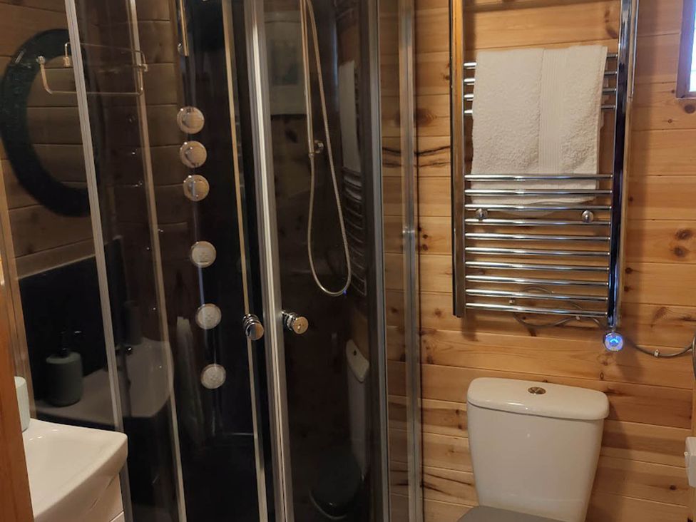 A bathroom with a shower, toilet, and towel radiator at Peaceful Cabin in Skegby -Sleeps2- Fire Pit Stanton Hill