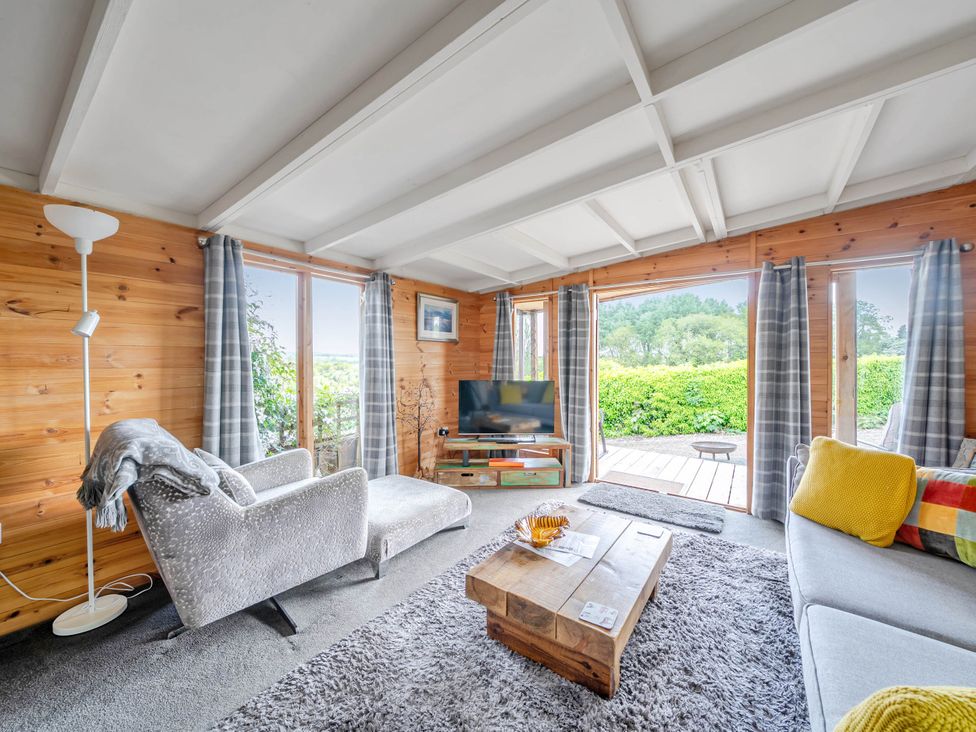 A living room with a sofa, coffee table, and television at Peaceful Cabin in Skegby -Sleeps2- Fire Pit, Stanton Hill