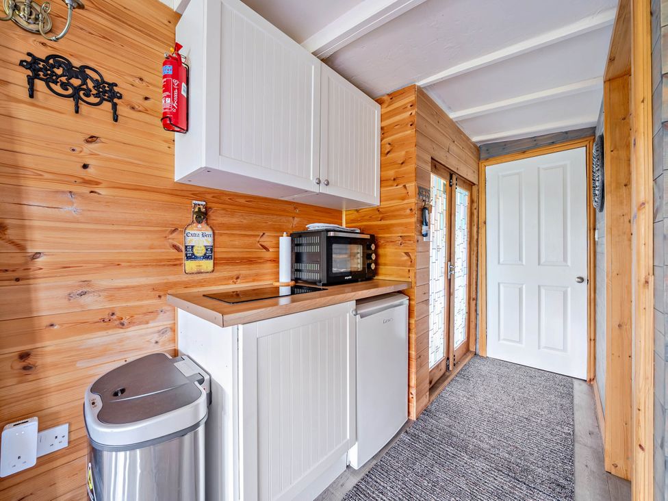 A kitchen with cabinets and a microwave at Peaceful Cabin in Skegby -Sleeps2- Fire Pit Stanton Hill