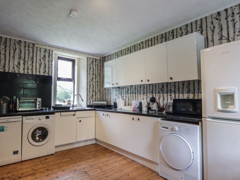 A kitchen with appliances and cabinets at Keepers Cottage in New Deer