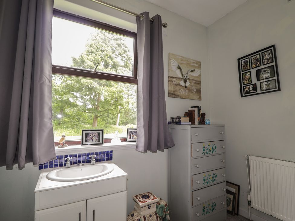 A bathroom with a sink and window at Keepers Cottage in New Deer