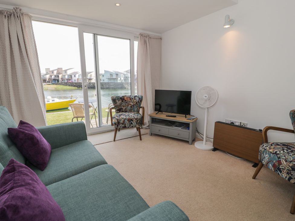 A living room with a sofa and television at Harbourside in Porthmadog