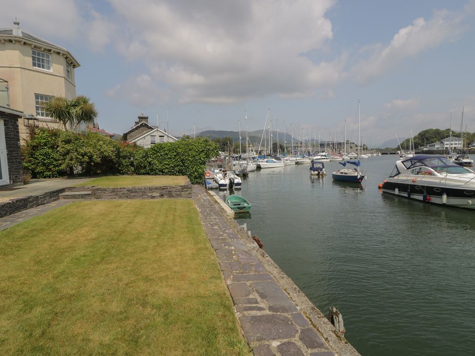 A view of the marina with boats and grass at Harbourside in Porthmadog