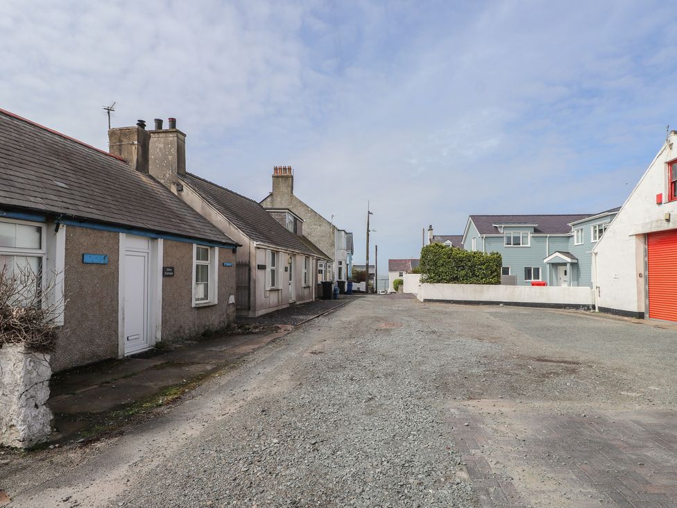 A street with houses and cloudy sky at Kiloran in Rhosneigr