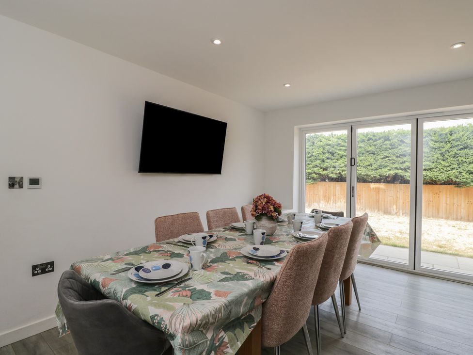 A dining room with a table set for meals at 1 Brunel Court