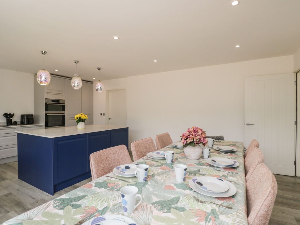 A kitchen with a dining table and kitchen island at 1 Brunel Court