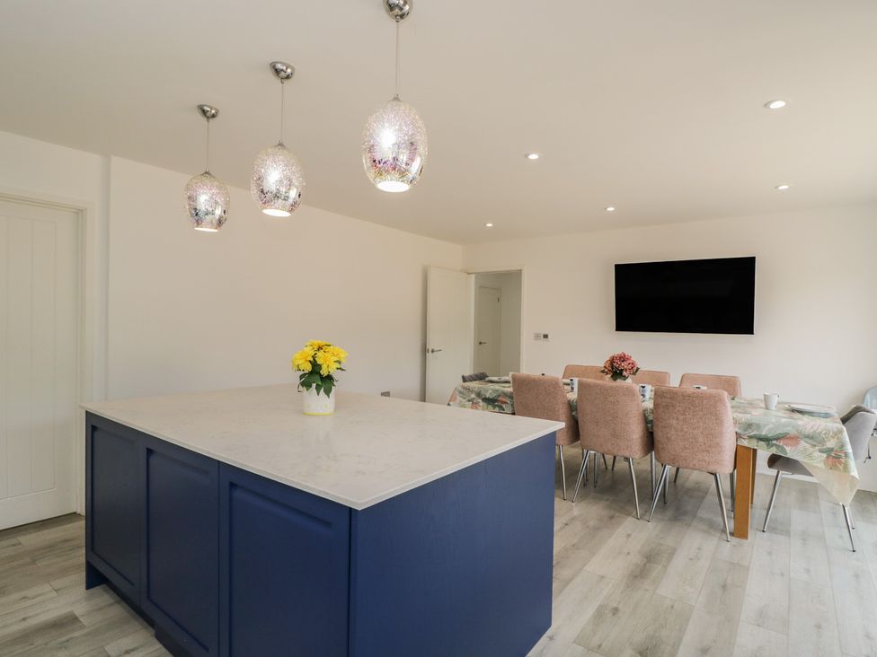 A kitchen with an island and dining area at 1 Brunel Court