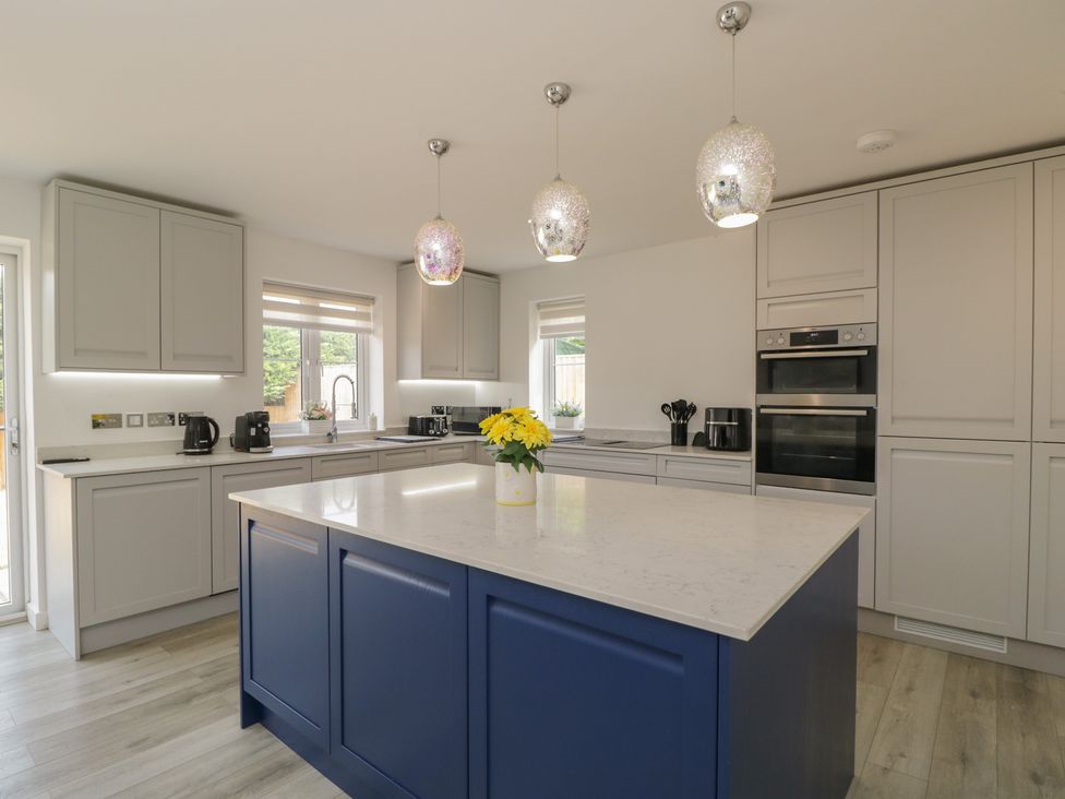 A kitchen with cabinets, appliances and an island at 1 Brunel Court