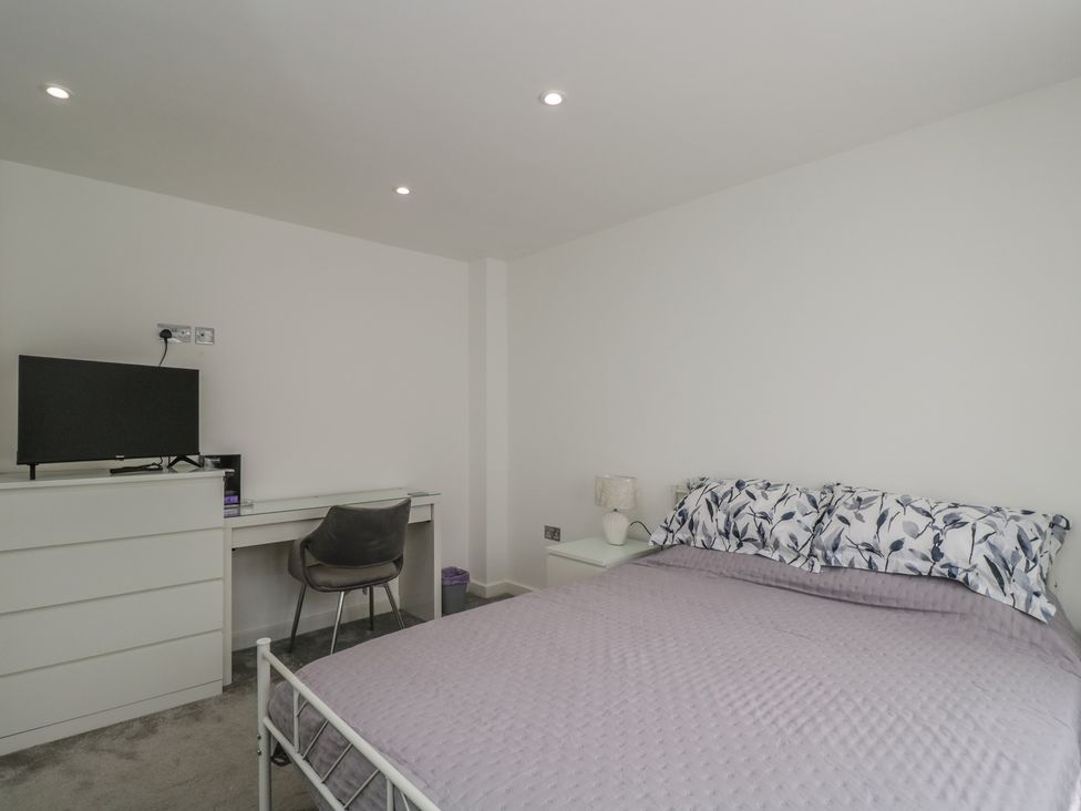 A bedroom with a bed and television at 1 Brunel Court 