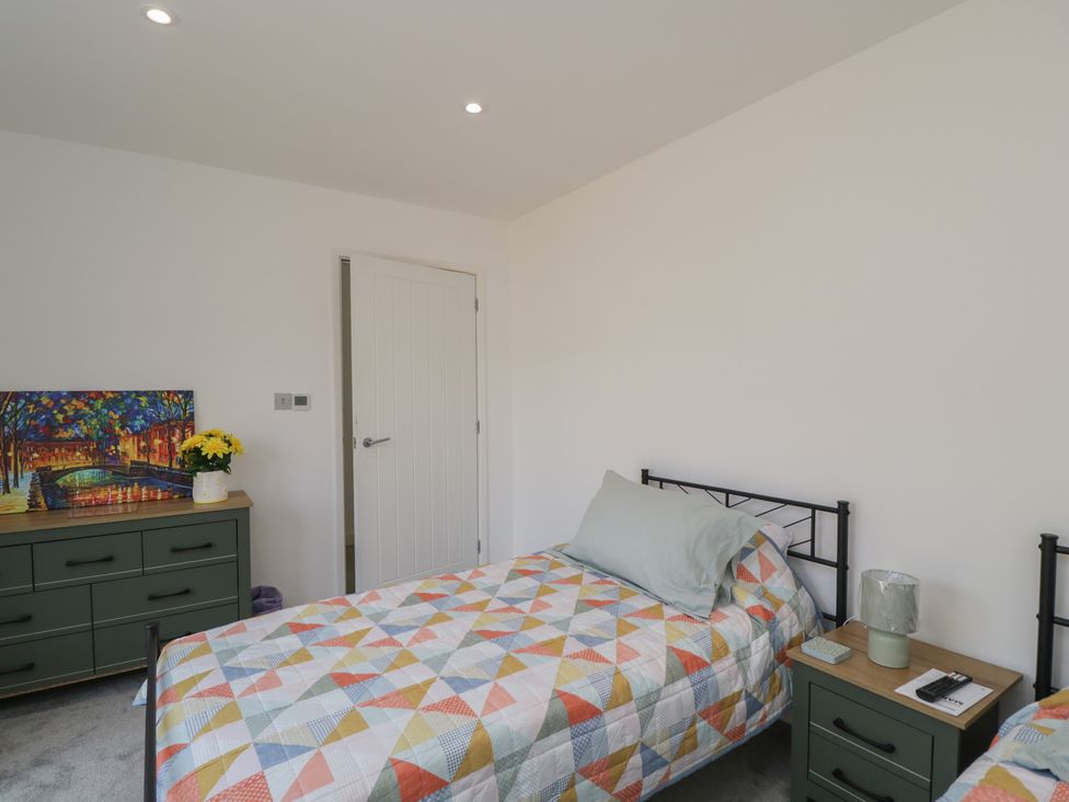 A bedroom with two beds and a dresser at 1 Brunel Court in 