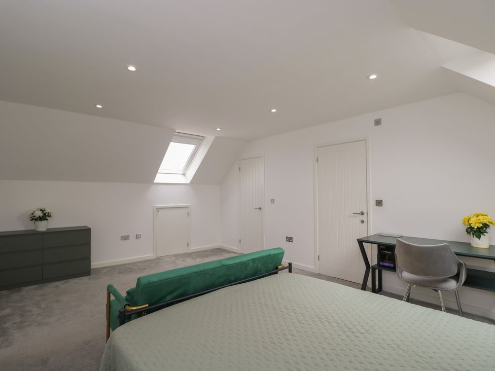A bedroom with a bed and desk at 1 Brunel Court