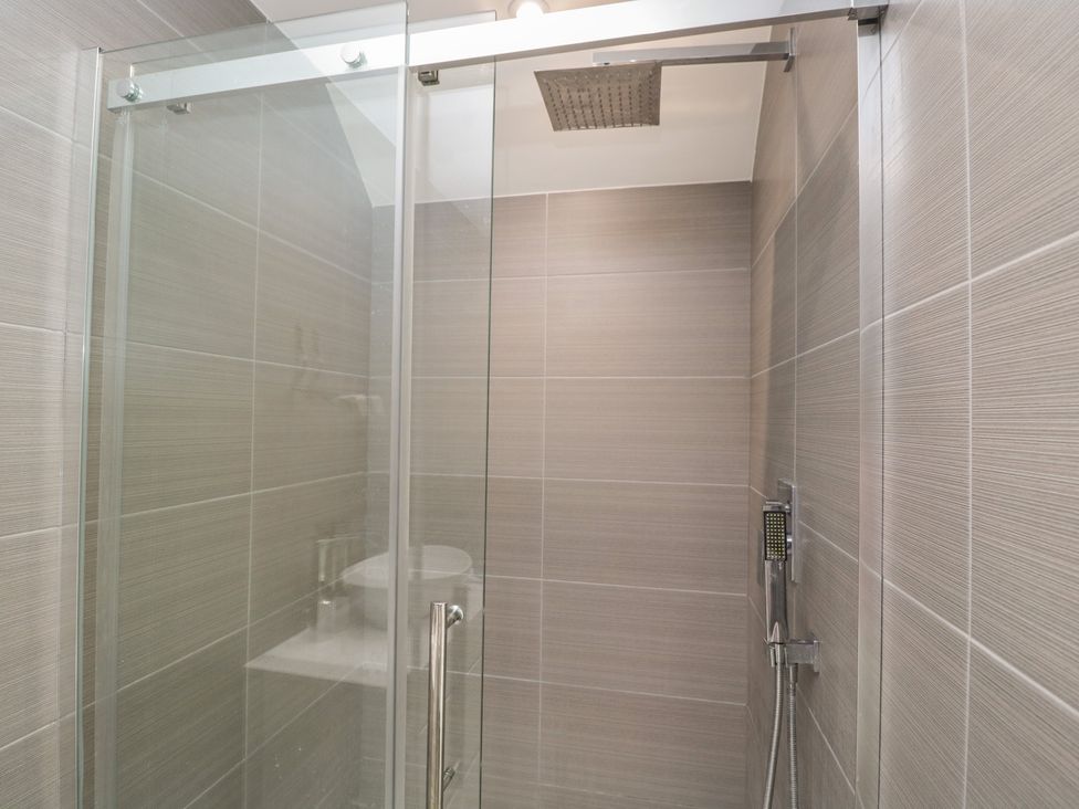 A shower area with glass door and modern fixtures at 1 Brunel Court