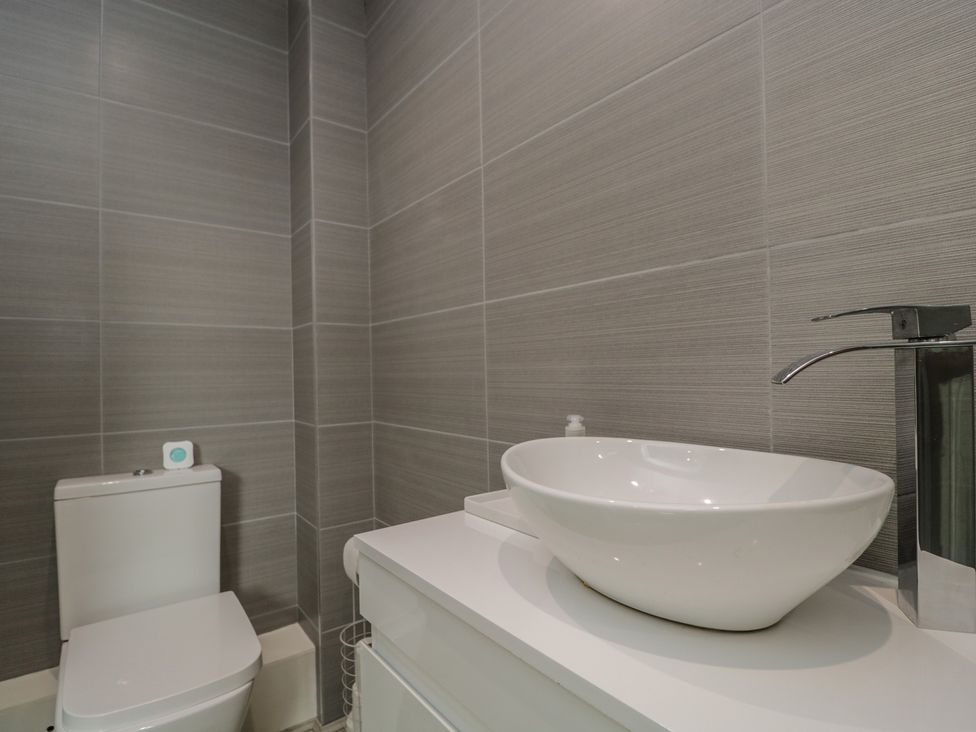 A bathroom with a toilet and a sink at 1 Brunel Court