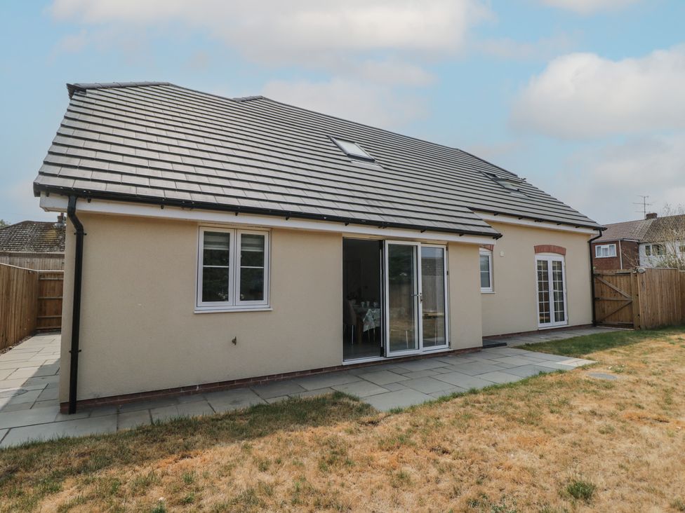 A house exterior with a patio and windows at 1 Brunel Court