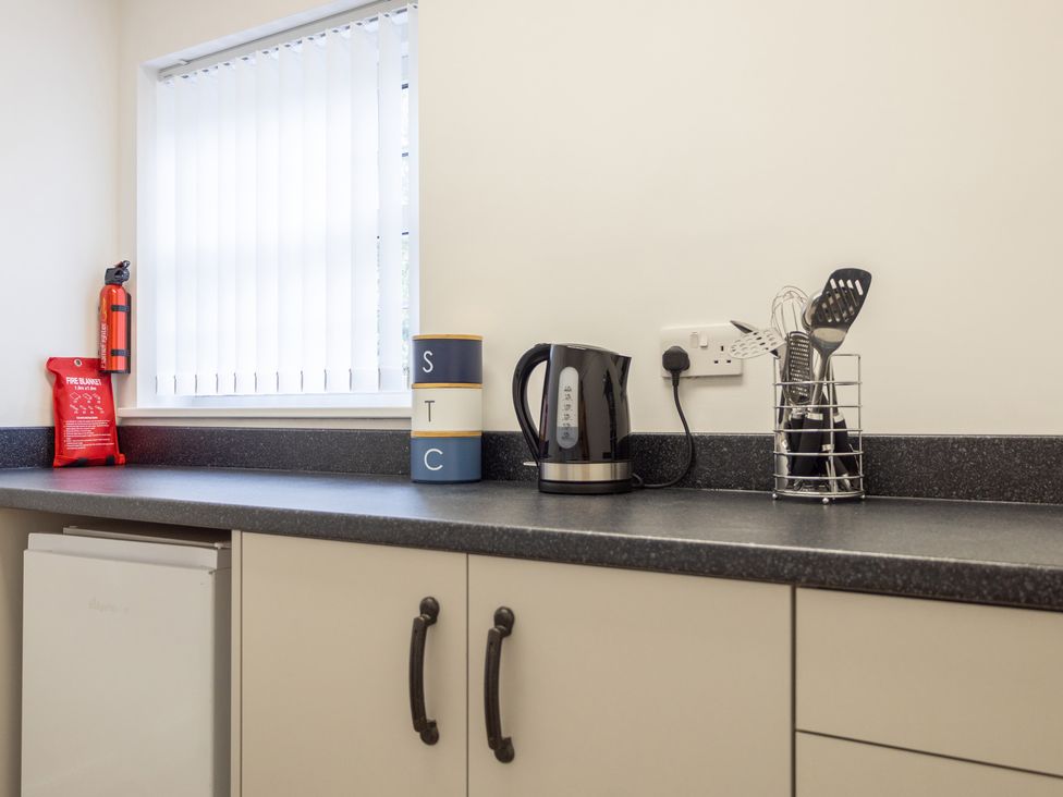 A kitchen with kettle and utensils on a countertop at Ivy House near Louth