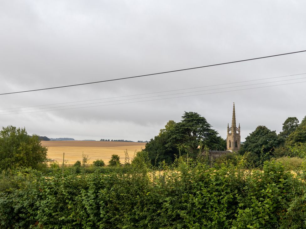 A view of a church and fields at Ivy House near Louth