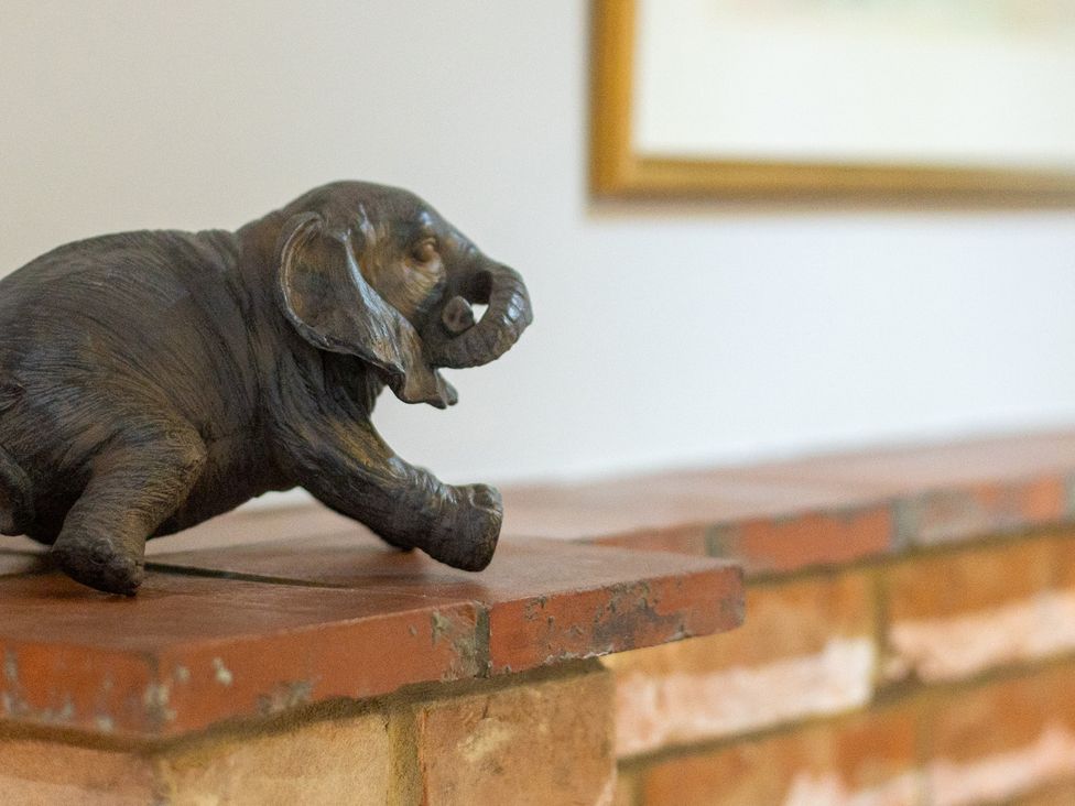 An elephant sculpture on a brick mantel at The Groom's Cottage, at Ivy House near Louth
