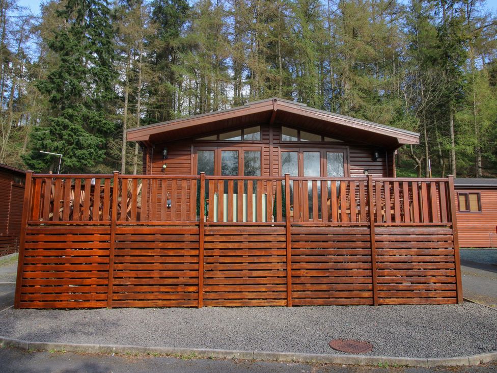 A cabin with decking and wooden railing at No.14 Astbury Falls Luxury Retreat in Bridgnorth
